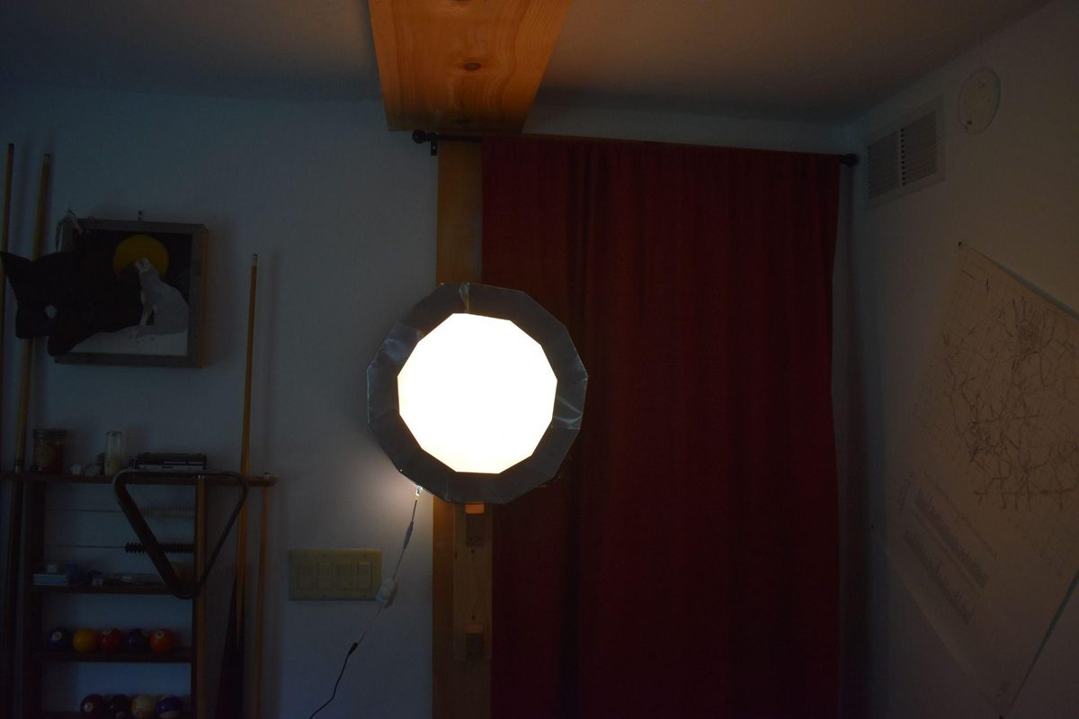 Hexagonal light fixture illuminated, installed on wall