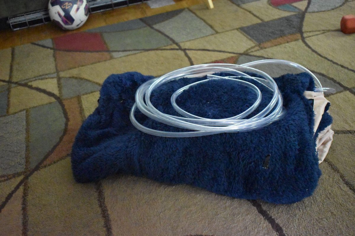 Sleeping bag system folded with cooling tubing visible