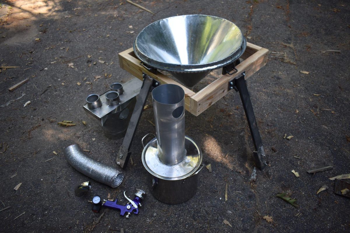 Spray dryer components laid out: funnel stand, cyclone separator, air distribution box